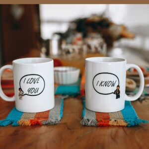 Two mugs of coffee on the table.