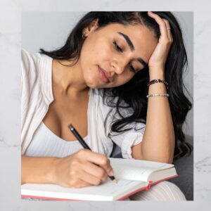 woman writing in a journal.