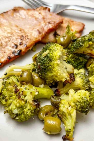 Spanish pork loin in adobo served with roasted broccoli and olives.