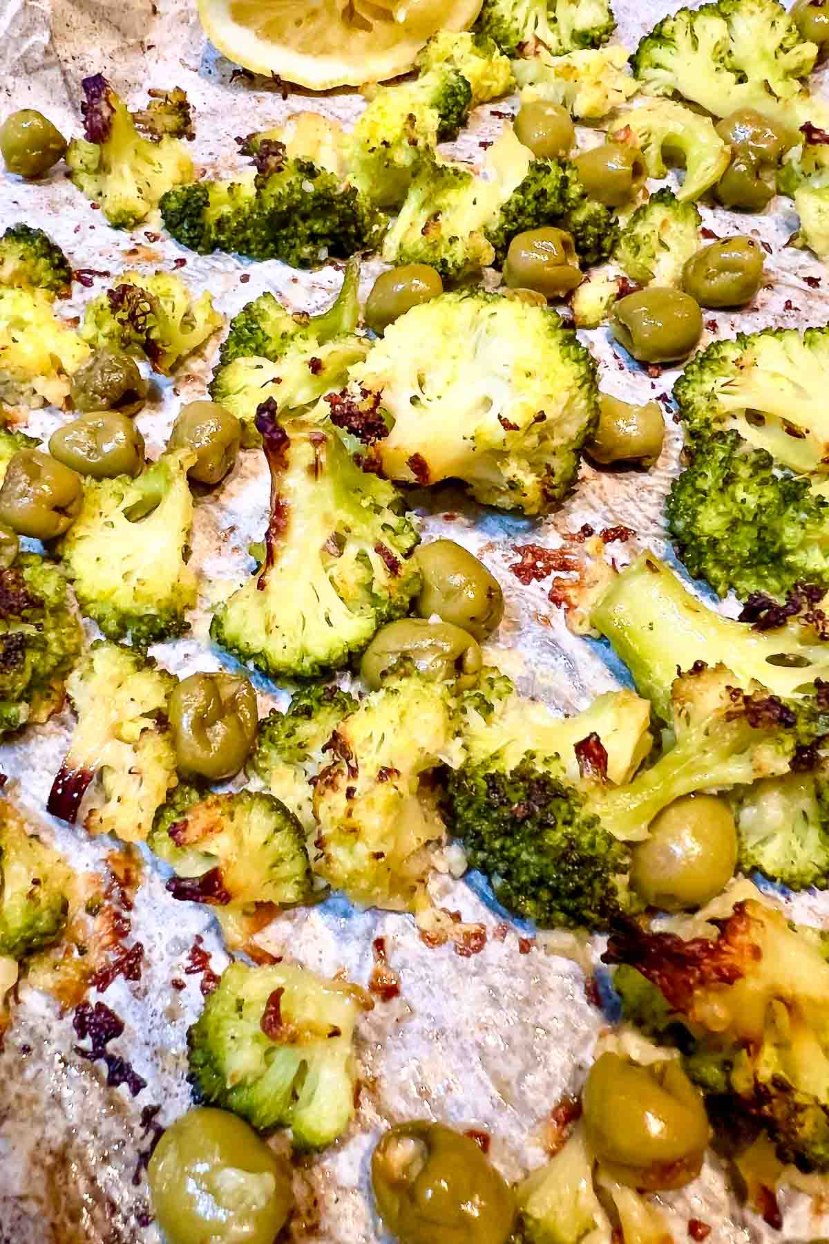 roasted broccoli and green olives in the pan.